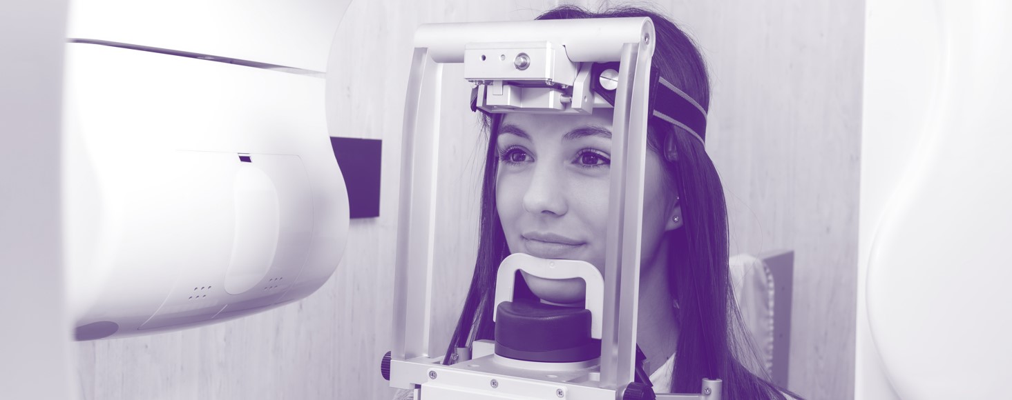 woman's head inside a medical device preparing for an X-ray