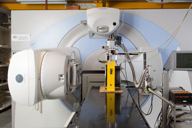 The primary standard graphite calorimeter (graphite block in the yellow wooden frame) mounted in front of the medical standards linac